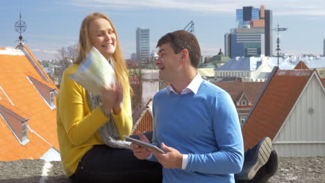 Man-and-woman-using-pad-and-map-in-city