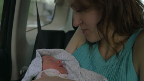 Newborn-Baby-Sleeping-on-Hands-of-His-Mother