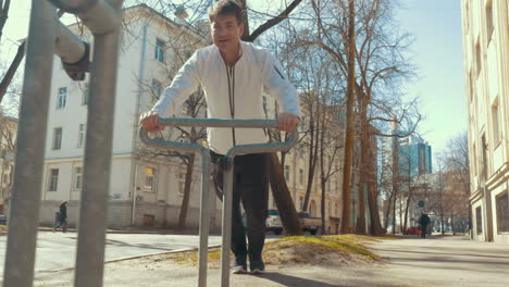 Man-doing-sports-using-bike-parking-rack