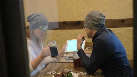 Young-people-having-nice-evening-with-beer-and-pad