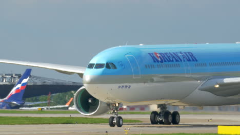 Passenger-airplane-passing-by-fire-engine-on-runway