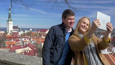 Man-and-woman-making-selfie-with-touchpad