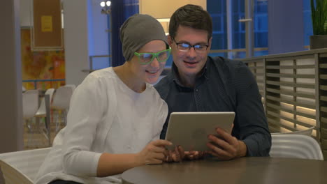 Man-and-woman-using-touch-pad-for-video-chatting