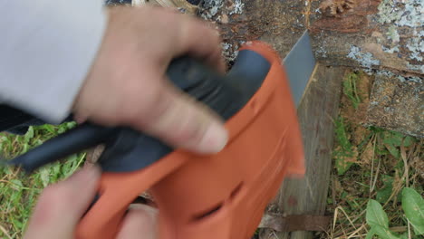 Man-sawing-the-wood-with-electric-tool