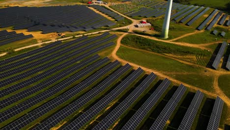Aerial-footage-of-solar-panels-plant-a-generating-green-electric-energy-on-a-wide-green-field-on-a-sunny-day,-in-Taurage,-Lithuania