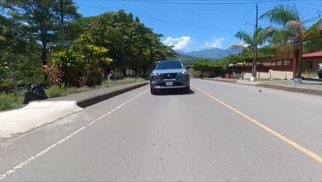 nissan-x-trail-driving-on-street-between-trees,compact-crossover-SUV,-crossover