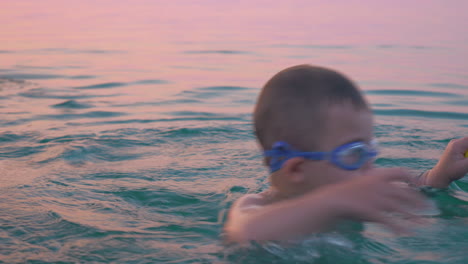 Little-boy-in-goggles-turning-around-himself