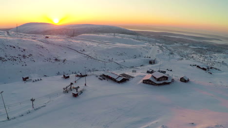 Flying-over-ski-resort-in-the-north-at-sunset