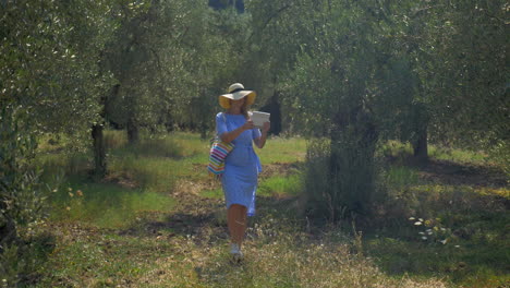 Woman-with-pad-walking-in-the-garden-or-woods