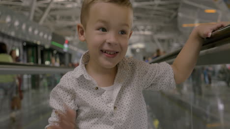 Little-child-riding-on-flat-escalator-and-posing