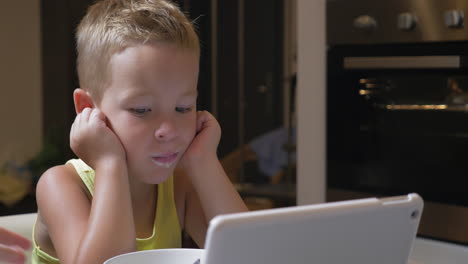 Child-having-meal-with-cartoons-on-pad