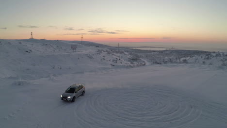 Car-drifting-on-snow-aerial-view