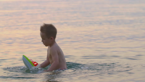 Boy-Playing-in-the-Sea-at-Sunset