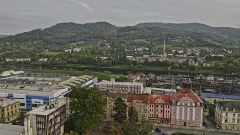 Decin-Czechia-Aerial-v7-low-level-drone-flyover-riverside-industrial-area-along-the-Elbe-river-channel-capturing-hillside-cityscape-views---Shot-with-Mavic-3-Cine---November-2022