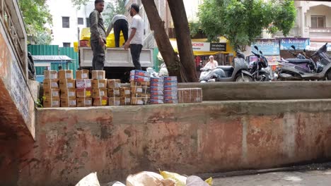 Workers-are-unloading-the-goods-from-the-pickup-trucks-in-India---Transportation