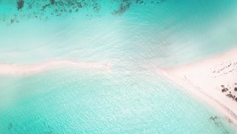 Aerial-top-view-clouds-pass-over-sandbank,-shadows-of-blue-water-sea-and-white-sand-paradise-found