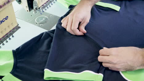 Man-in-a-sewing-factory-checking-the-t-shirt-sewing