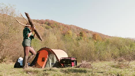 Friends-with-fire-wood-for-camp-fire-near-the-tent