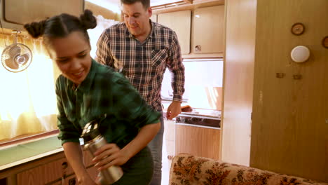 Happy-young-couple-entering-in-their-retro-camper-van