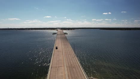 DuPont-Bridge,-Panorama-City,-Florida---Vehicles-Traversing-a-Bridge-Spanning-Across-a-Body-of-Water---Aerial-Drone-Shot