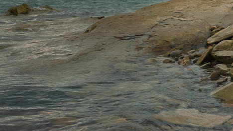 Wavy-Water-And-Rocky-Shore-Of-Lake