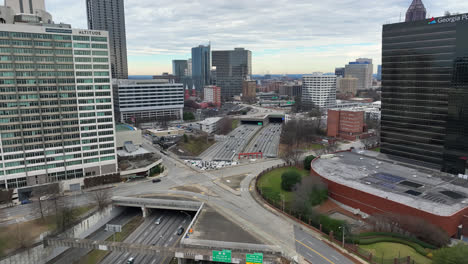 Aerial-view-of-Downtown-Atlanta-Georgia-buildings-and-Peachtree-Street-with-traffic-movement,-Famous-tourist-attraction-Folk-Art-Park