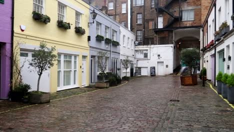 Charming-row-of-different-houses-with-pastel-colors-in-Conduit-Mews,-London