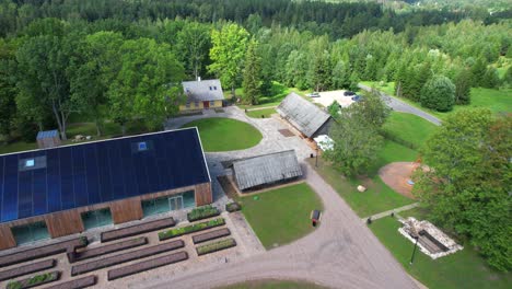 drone-flight-over-old-wooden-farm-in-Valgamaa-over-green-summer-forests