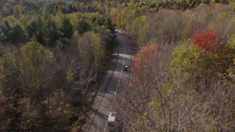 Car-and-Van-drive-on-Grafton-Notch-State-Park-highway-during-golden-hour