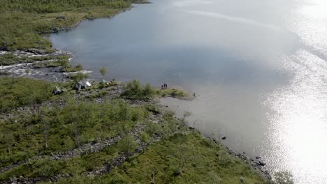 Closing-drone-shot-of-campers-in-the-wilderness-close-to-lake