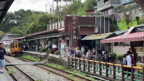 Tourists-visit-the-famous-Shifen-Railway-Station,-a-bustling-hub-of-an-old-railroad-town-that-retains-the-charm-of-yesteryear-in-Taipei,-Taiwan