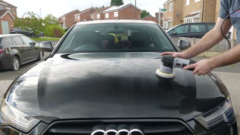 Polishing-a-black-car-bonnet-hood-with-a-machine-polisher