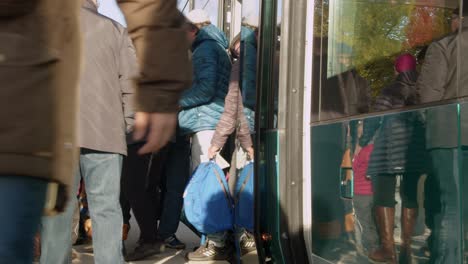 Passengers-exit-shiny-clean-transit-train-on-Helsinki-street-platform