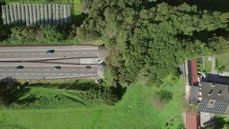 Highway,-cars-going-into-tunnel,-top-down-drone-view