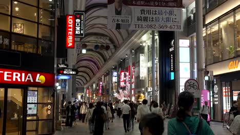 Slow-motion-view-inside-Hiroshima-Hondori-Shopping-Street-with-crowd-of-people-at-night,-Japan