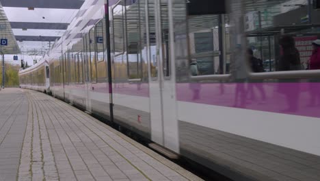 Clean-public-transit-train-arrives-at-train-station-in-Kerava,-Finland