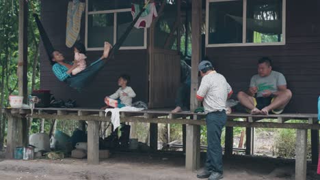 A-group-of-indigenous-People-spending-time-in-the-jungle-during-rain,-Amazon-Peru