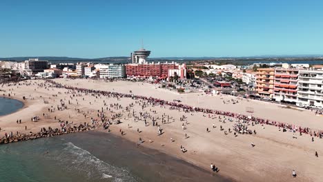Crowded-beach-with-hotels-and-apartment-buildings-aerial-view-in-Palavas,-France
