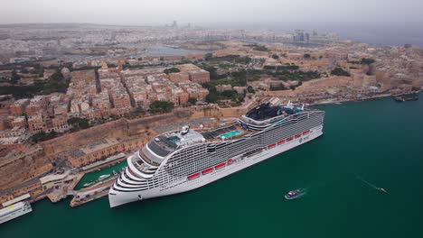 Luxury-Cruise-Ship-Docked-in-Malta-Harbour-next-to-Valletta-Old-Town