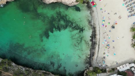Isolated-beach-on-the-east-of-Mallorca-with-crystal-clear-water,-aerial