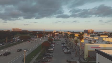 An-aerial-establishing-shot-of-NASA-Road-1,-featuring-Johnson-Space-Center,-Houston-Methodist-Hospital,-Hilton-Hotel,-and-Endeavor-Condominiums-at-sunset-in-Clear-Lake,-Houston,-Texas