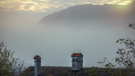 Timelapse-of-foggy-morning-sunrise-in-hilly-town-of-the-Austrian-Alps,-Sunrise-over-alps,-Europe