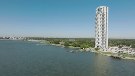 An-aerial-establishing-shot-of-the-Endeavour-high-rise,-a-luxurious-30-story-modern-high-rise-building-located-in-Seabrook,-TX,-with-unparalleled-views-of-the-Clear-Lake-area-and-the-Houston-skyline
