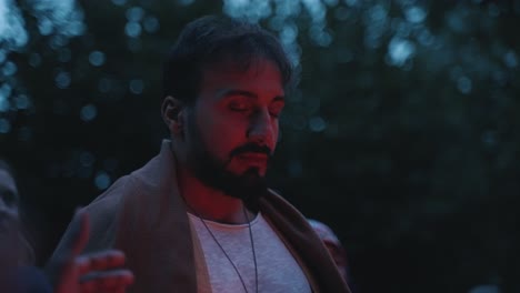 A-young-spiritual-man-having-his-eyes-closed-during-a-shaman-ceremony-in-the-evening