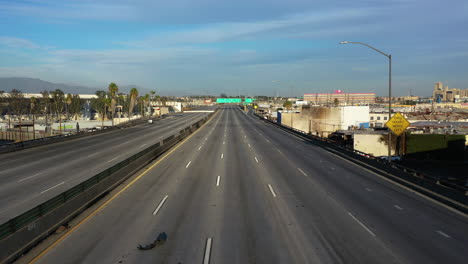 Aerial-view-following-a-damaged-and-closed-multi-lane-freeway,-in-Los-Angeles