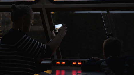 Mother-and-child-on-night-touristic-water-travel-in-Amsterdam