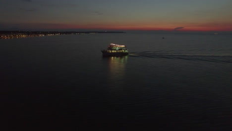 Aerial-view-of-sailing-touristic-ship-at-night