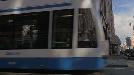 Street-with-moving-tram-in-Amsterdam