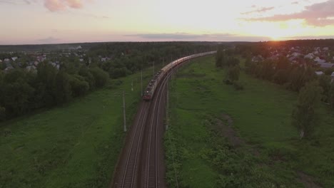 Cargo-train-crossing-countryside-at-sunset-Russia