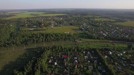 Summer-houses-in-the-countryside-and-freight-train-aerial-view